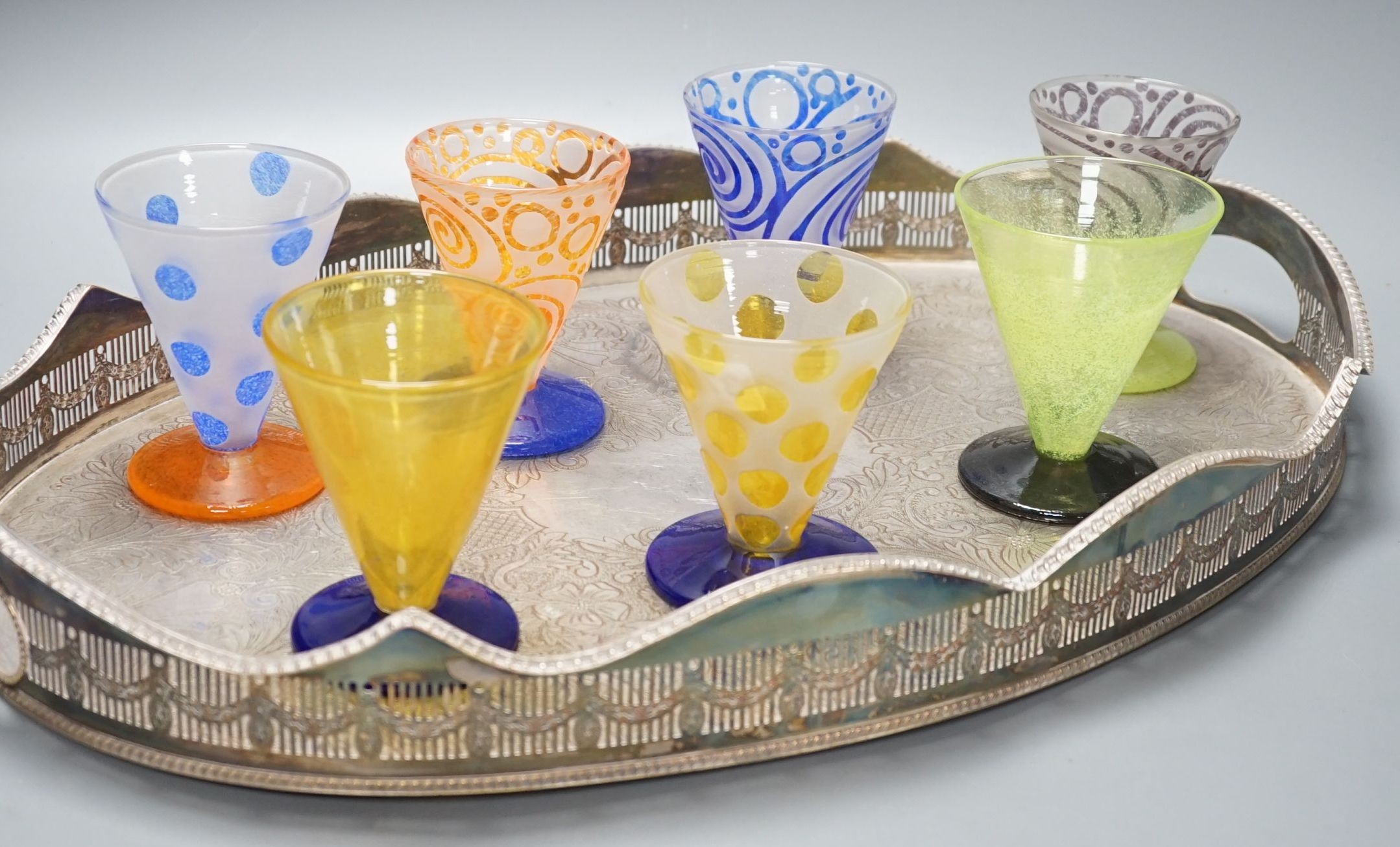 A plated tea tray, 7 art glass glasses and a Markus Karl Losse ‘World Wheels’ tie